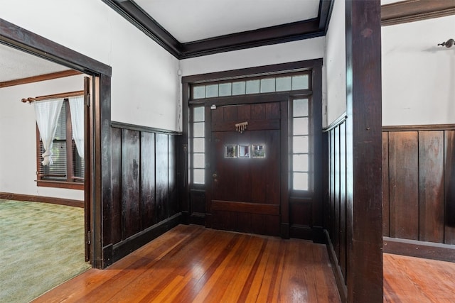 carpeted entryway with crown molding