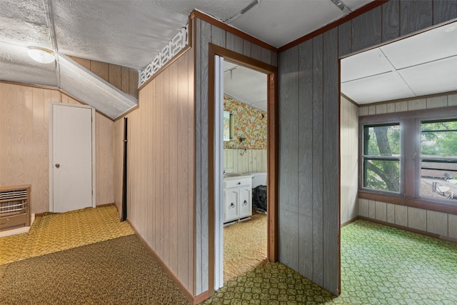 corridor with tile flooring and wood walls