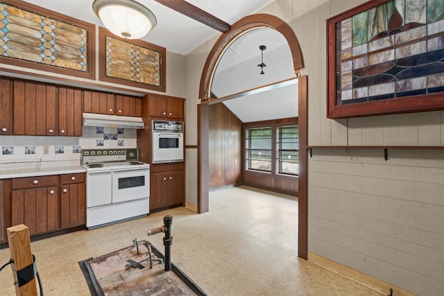 kitchen featuring vaulted ceiling with beams, white appliances, and backsplash