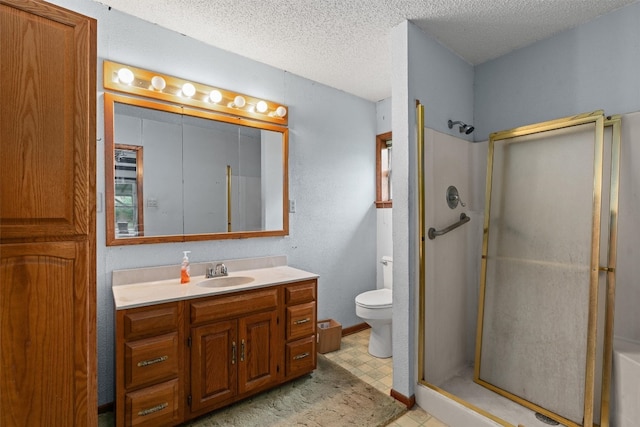 bathroom with toilet, tile floors, a shower with shower door, vanity, and a textured ceiling