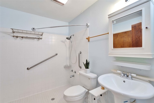 bathroom with sink, tile patterned flooring, toilet, and tiled shower