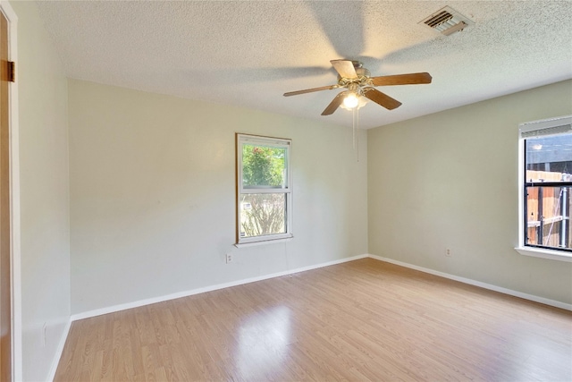 unfurnished room with light wood-type flooring, a textured ceiling, and ceiling fan