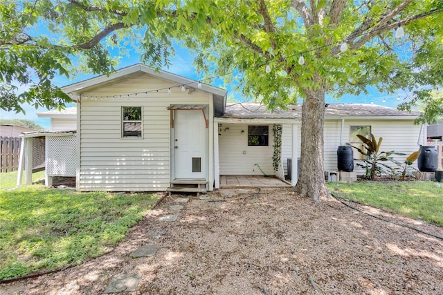 rear view of property featuring a yard