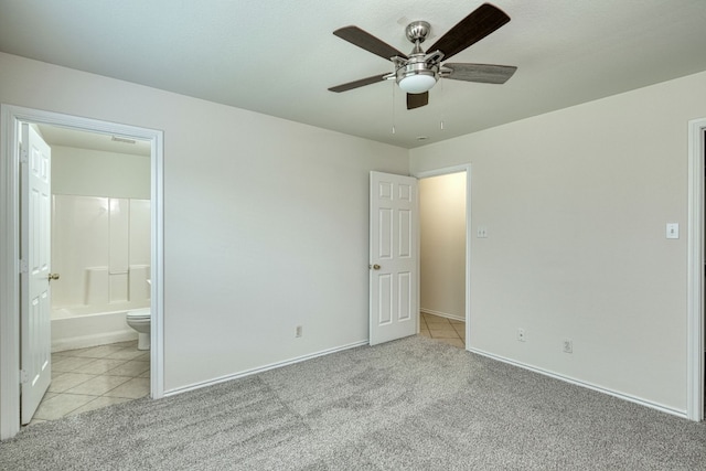 unfurnished bedroom featuring light carpet, ensuite bathroom, and ceiling fan