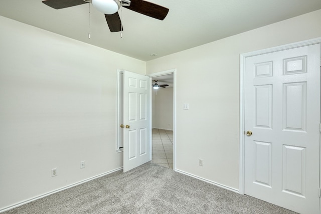 unfurnished bedroom with tile flooring and ceiling fan