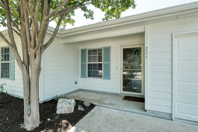 view of exterior entry featuring a garage