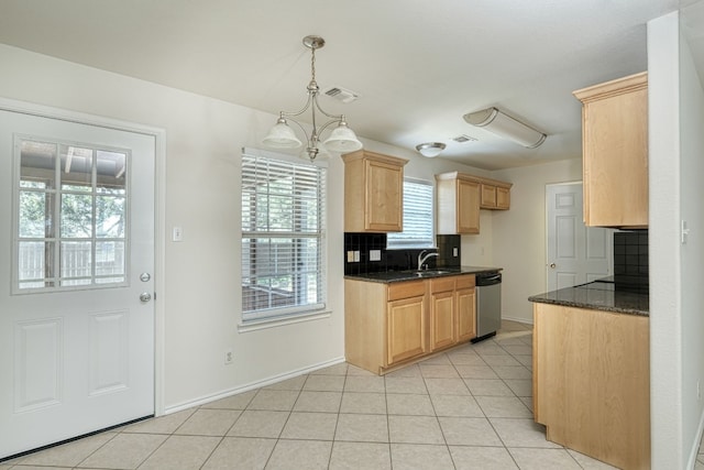 kitchen featuring decorative light fixtures, tasteful backsplash, light tile floors, and stainless steel dishwasher