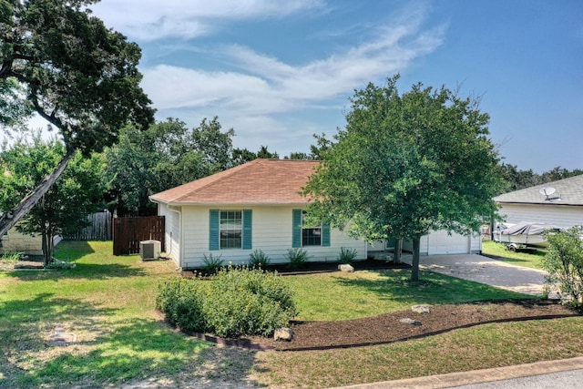 view of front facade with a garage, central AC, and a front lawn