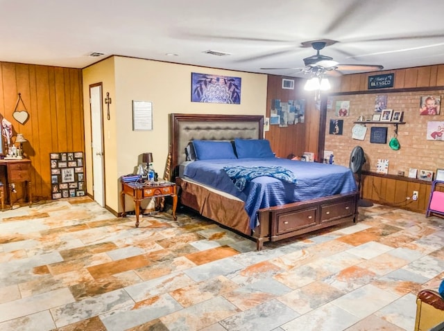 bedroom with ceiling fan and wooden walls