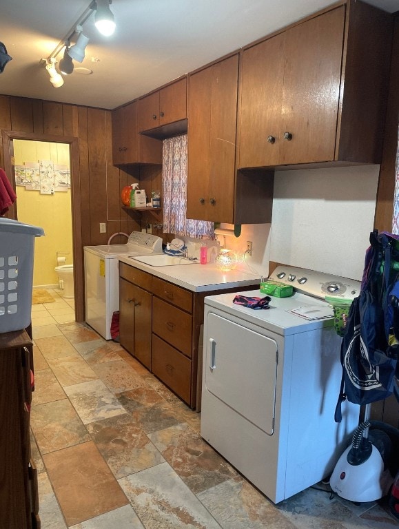 kitchen featuring independent washer and dryer and sink