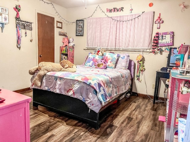 bedroom featuring dark hardwood / wood-style flooring