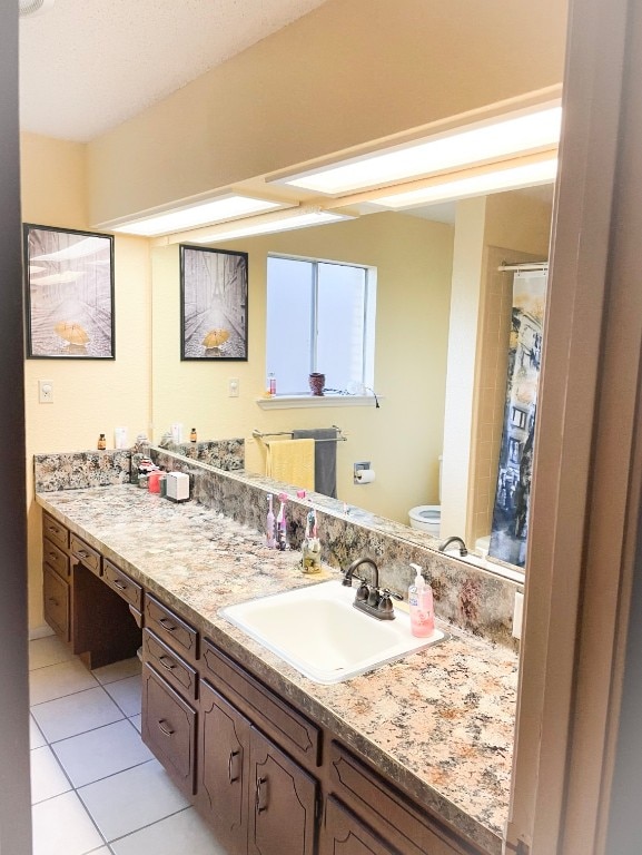 bathroom featuring vanity, curtained shower, toilet, and tile patterned floors