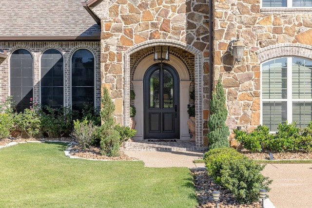 doorway to property with a yard