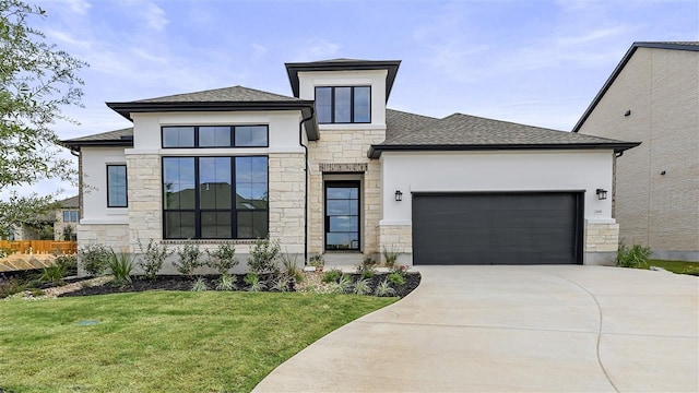 view of front of house featuring a garage and a front lawn