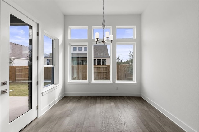 unfurnished sunroom with a notable chandelier