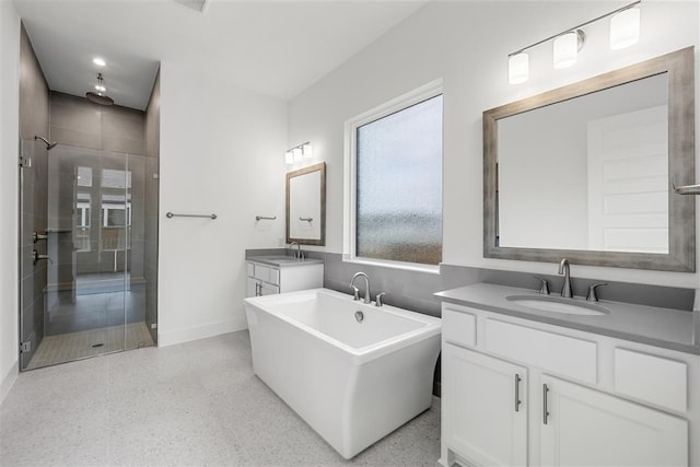 bathroom featuring shower with separate bathtub and vanity