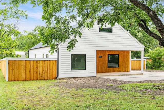 rear view of house with a patio area and a yard