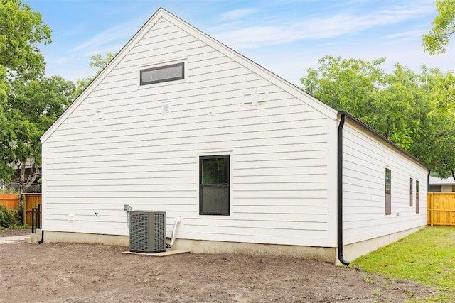 view of side of home featuring central AC unit