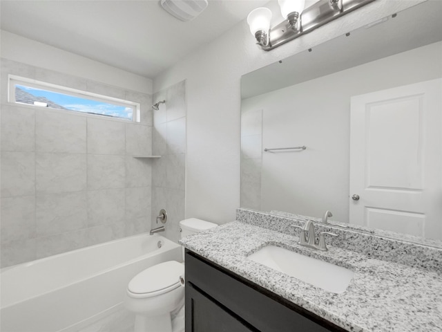 full bathroom with tiled shower / bath, toilet, and vanity