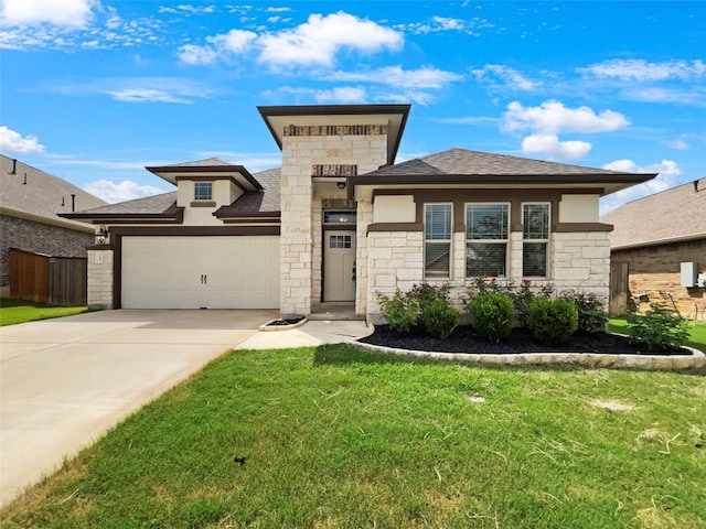 prairie-style house with a garage and a front lawn