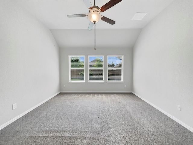 carpeted spare room with ceiling fan and lofted ceiling