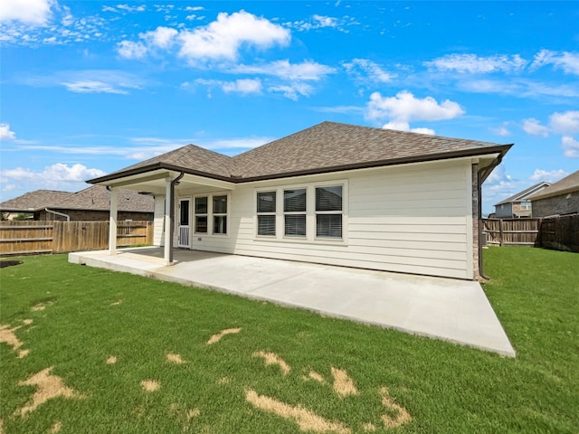 back of property with a lawn and a patio