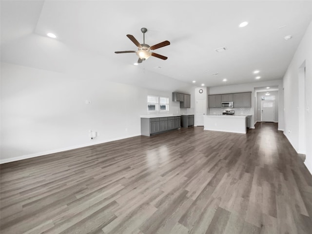 unfurnished living room featuring ceiling fan and hardwood / wood-style flooring