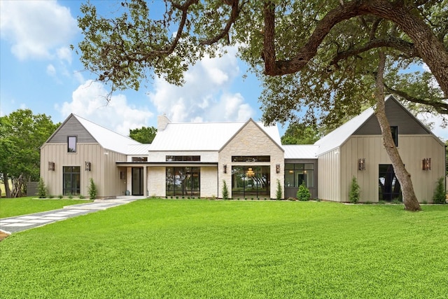 modern inspired farmhouse with a front lawn