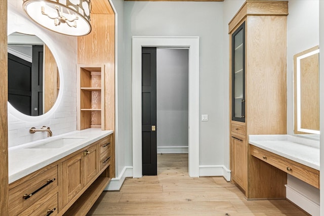 bathroom with hardwood / wood-style flooring and vanity