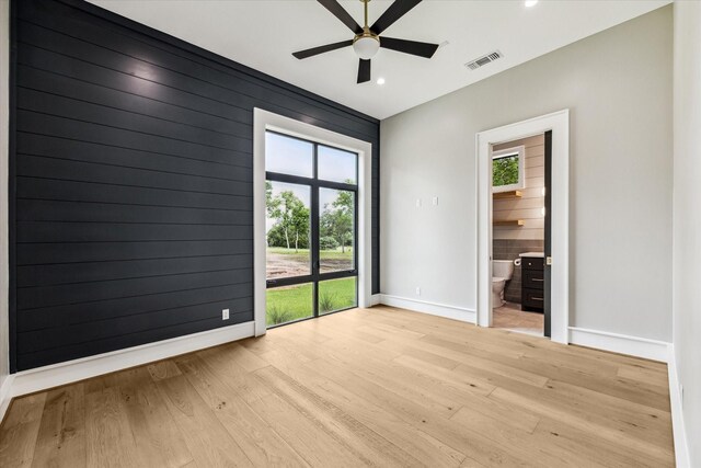 empty room featuring ceiling fan and light hardwood / wood-style flooring