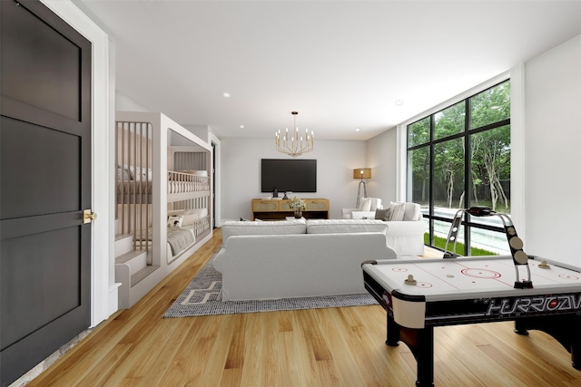 interior space featuring a wall of windows, light hardwood / wood-style floors, and a notable chandelier