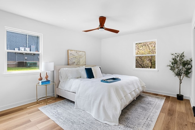 bedroom with light wood-type flooring and ceiling fan