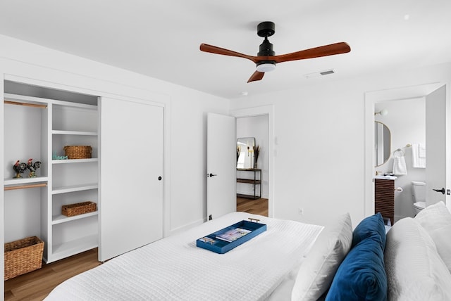 bedroom featuring connected bathroom, a closet, ceiling fan, and dark hardwood / wood-style floors