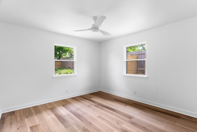 empty room with light wood-type flooring and ceiling fan