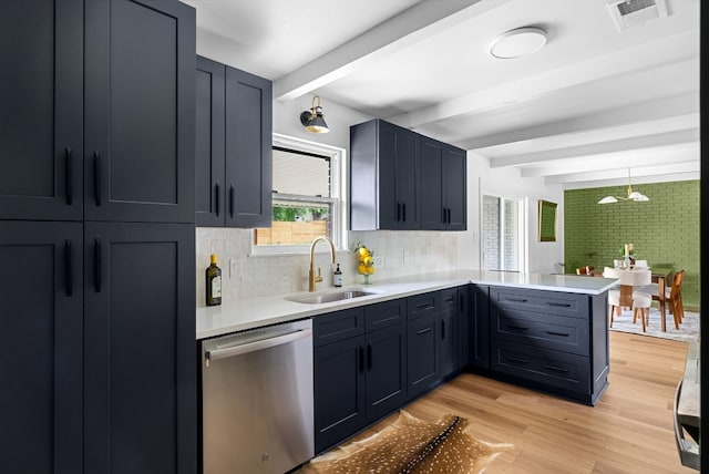 kitchen featuring beamed ceiling, sink, tasteful backsplash, and dishwasher