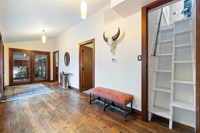 entryway with dark wood-type flooring, french doors, and vaulted ceiling