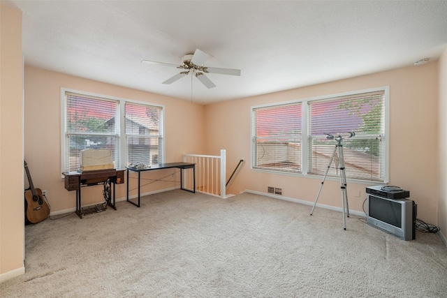 miscellaneous room with a healthy amount of sunlight, ceiling fan, and carpet floors