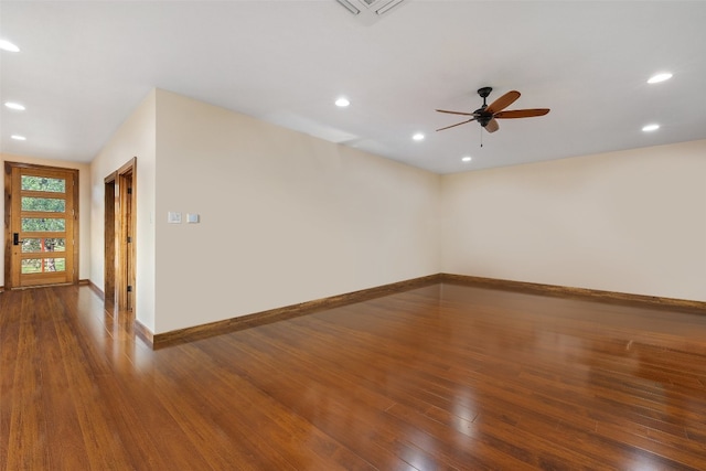 spare room with dark wood-type flooring and ceiling fan