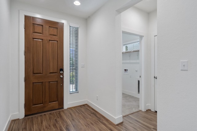 foyer entrance with a wealth of natural light and hardwood / wood-style floors