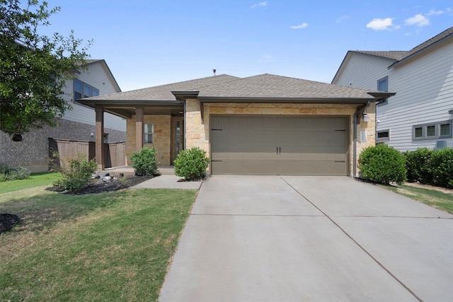 view of front of property featuring a garage and a front lawn