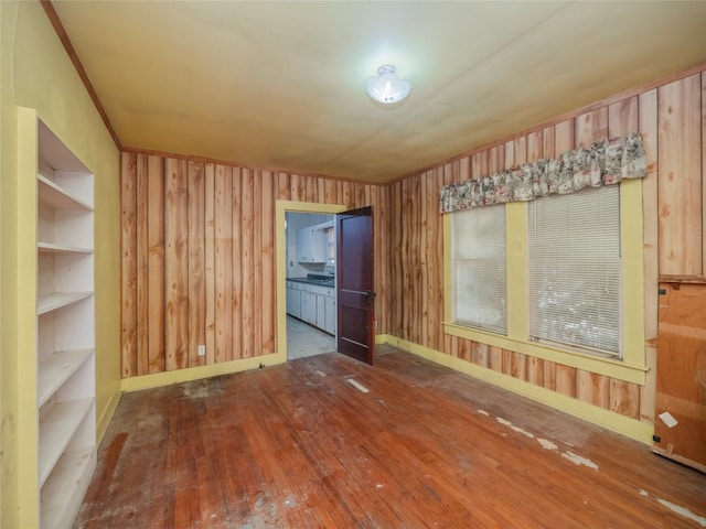 spare room with wooden walls and hardwood / wood-style floors