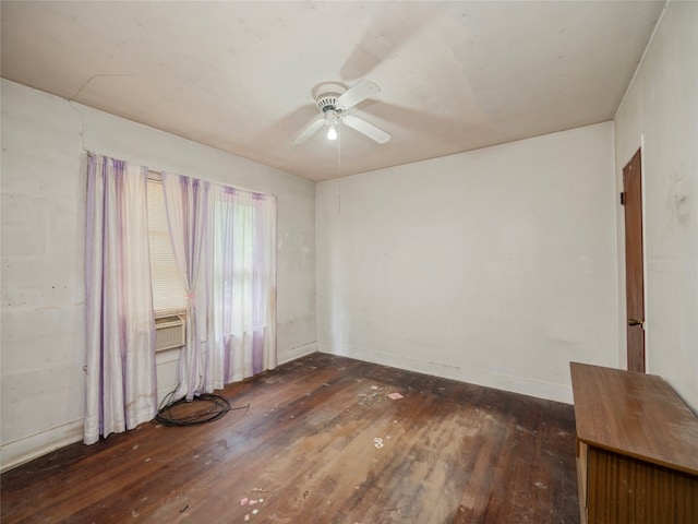 unfurnished room featuring dark wood-type flooring and ceiling fan