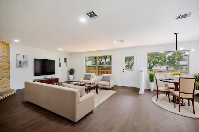 living room with an inviting chandelier and hardwood / wood-style flooring