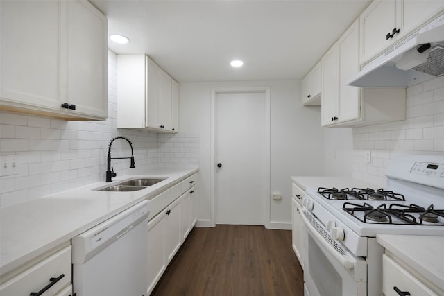 kitchen with white appliances, dark hardwood / wood-style flooring, sink, backsplash, and white cabinetry