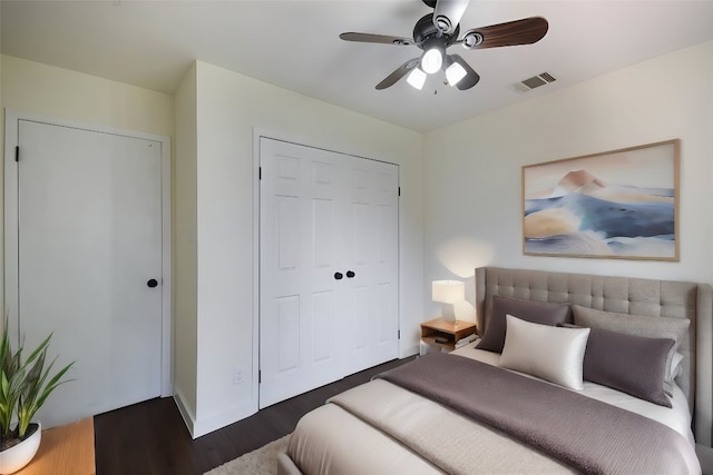 bedroom with ceiling fan, a closet, and dark hardwood / wood-style floors