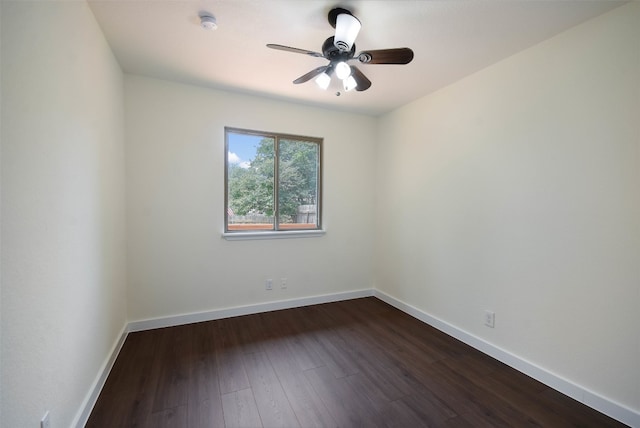 spare room featuring dark hardwood / wood-style flooring and ceiling fan