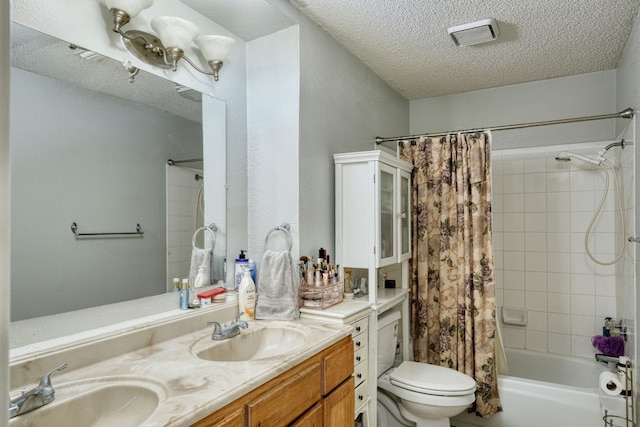 full bathroom featuring dual sinks, oversized vanity, shower / bath combo, a textured ceiling, and toilet