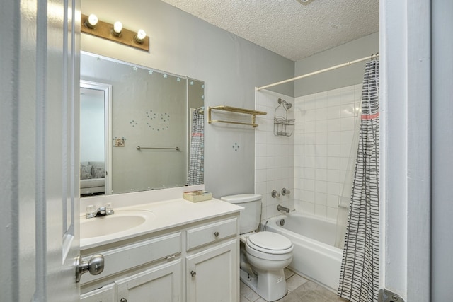 full bathroom featuring tile flooring, vanity with extensive cabinet space, a textured ceiling, shower / tub combo with curtain, and toilet