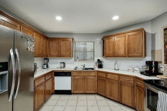 kitchen featuring sink, dishwasher, stainless steel fridge, and light tile floors