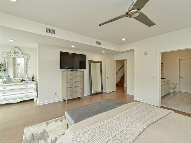 bedroom featuring wood-type flooring, ensuite bath, and ceiling fan